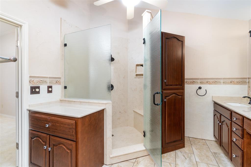 1106 Tahlequah Trail Carrollton, TX 75007 - Photo 13 of 20 a bathroom with a sink a mirror and a shower