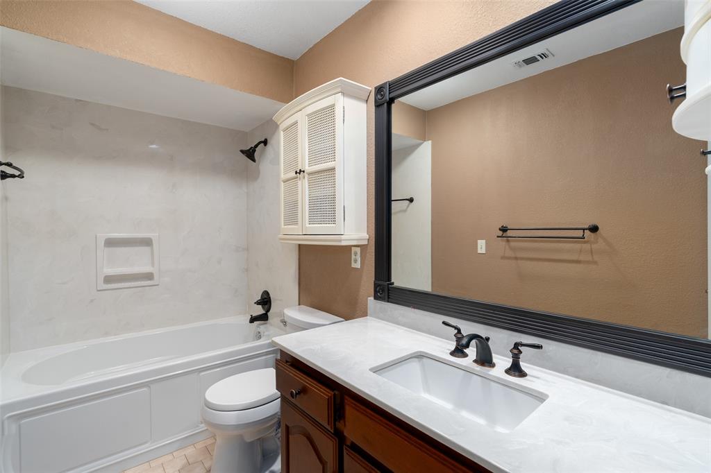 1106 Tahlequah Trail Carrollton, TX 75007 - Photo 15 of 20 a bathroom with a sink toilet tub and shower