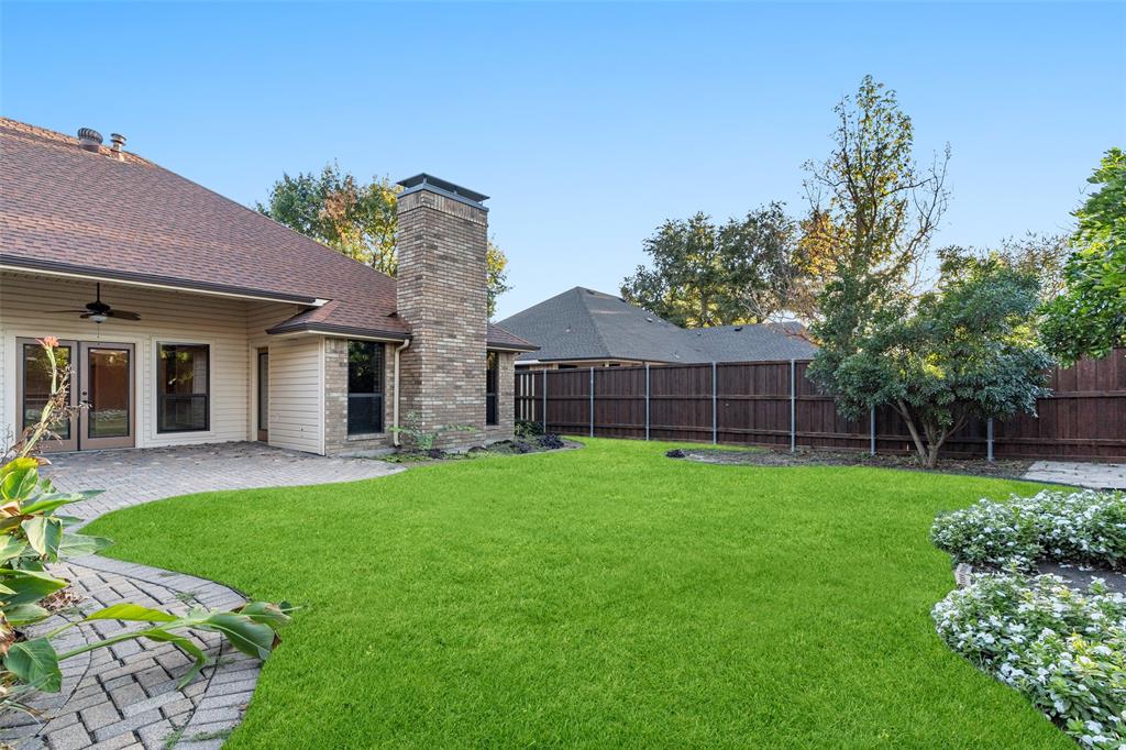 1106 Tahlequah Trail Carrollton, TX 75007 - Photo 19 of 20 a front view of a house with a yard and garage