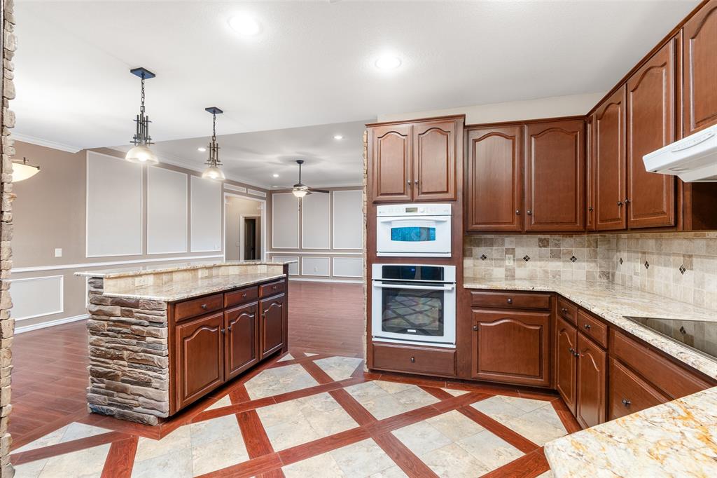 1106 Tahlequah Trail Carrollton, TX 75007 - Photo 8 of 20 a kitchen with stainless steel appliances granite countertop a stove a sink and a microwave