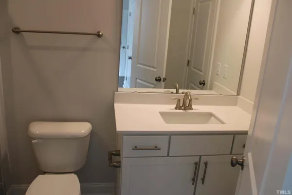 an empty room with wooden floor and fireplace