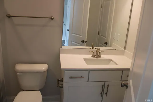 an empty room with wooden floor and fireplace