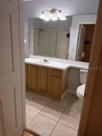 a bathroom with a sink a toilet and mirror