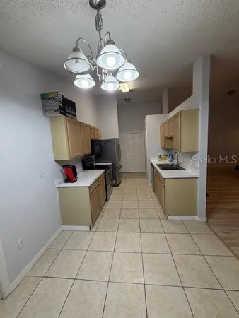 a kitchen with cabinets and window