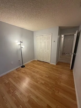 a view of a room with wooden floor and windows