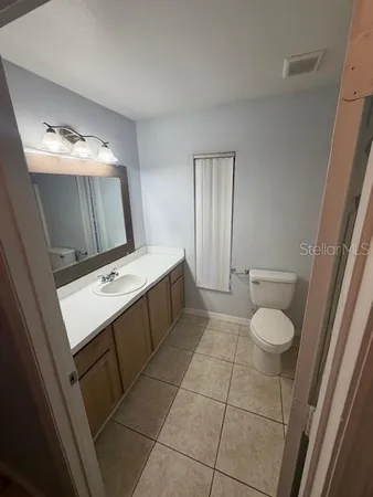 a bathroom with a sink toilet and mirror
