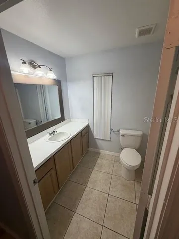 a bathroom with a sink toilet and mirror