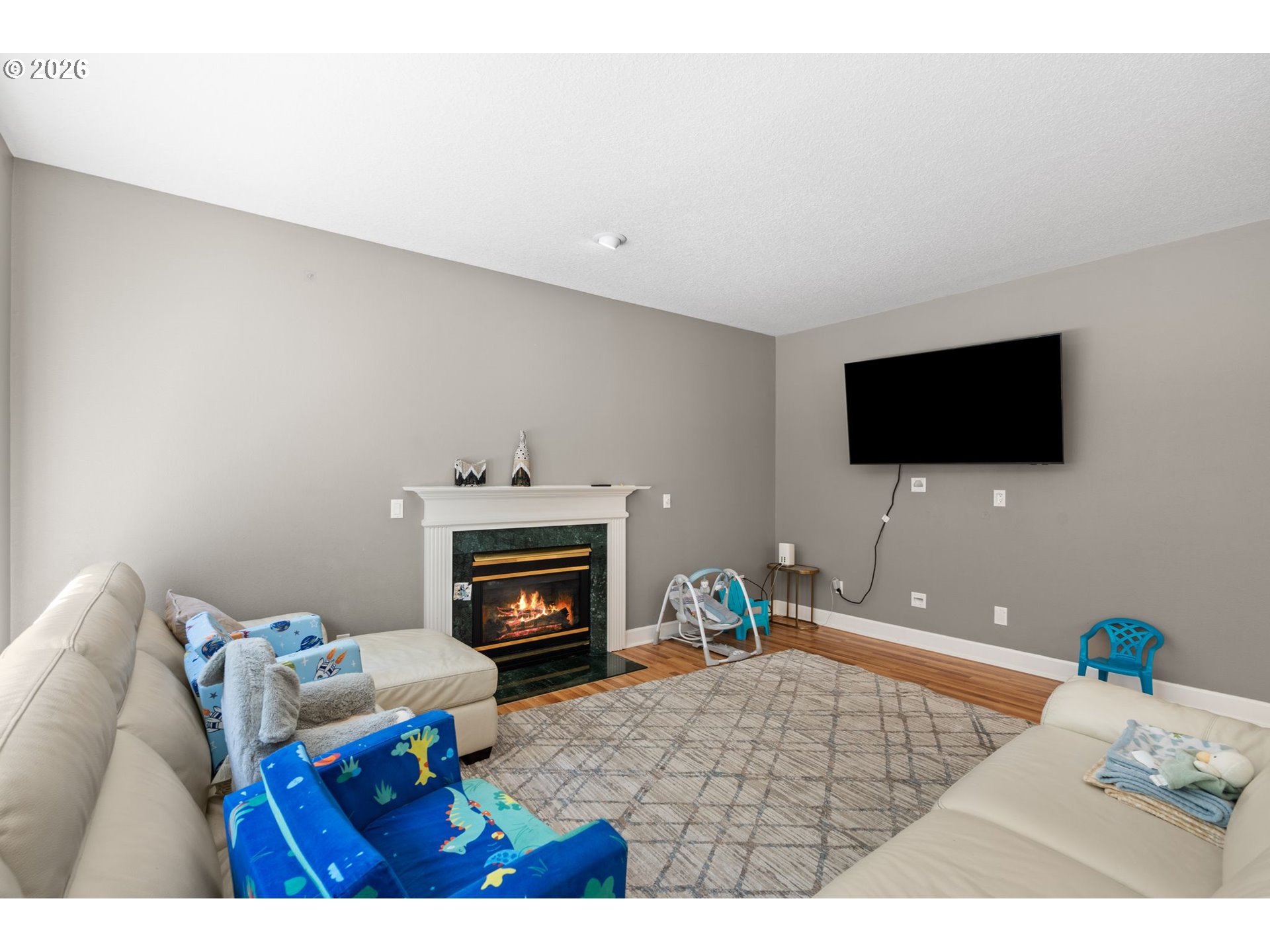 4000 Southwest 30th Drive Gresham, OR 97080 - Photo 26 of 45 a living room with furniture a flat screen tv and a fireplace