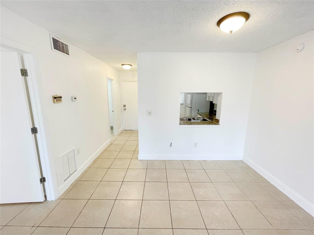 2800 Northwest 56th Avenue, Unit D402 Lauderhill, FL 33313 - Photo 2 of 14 a view of a livingroom with an empty space and a window