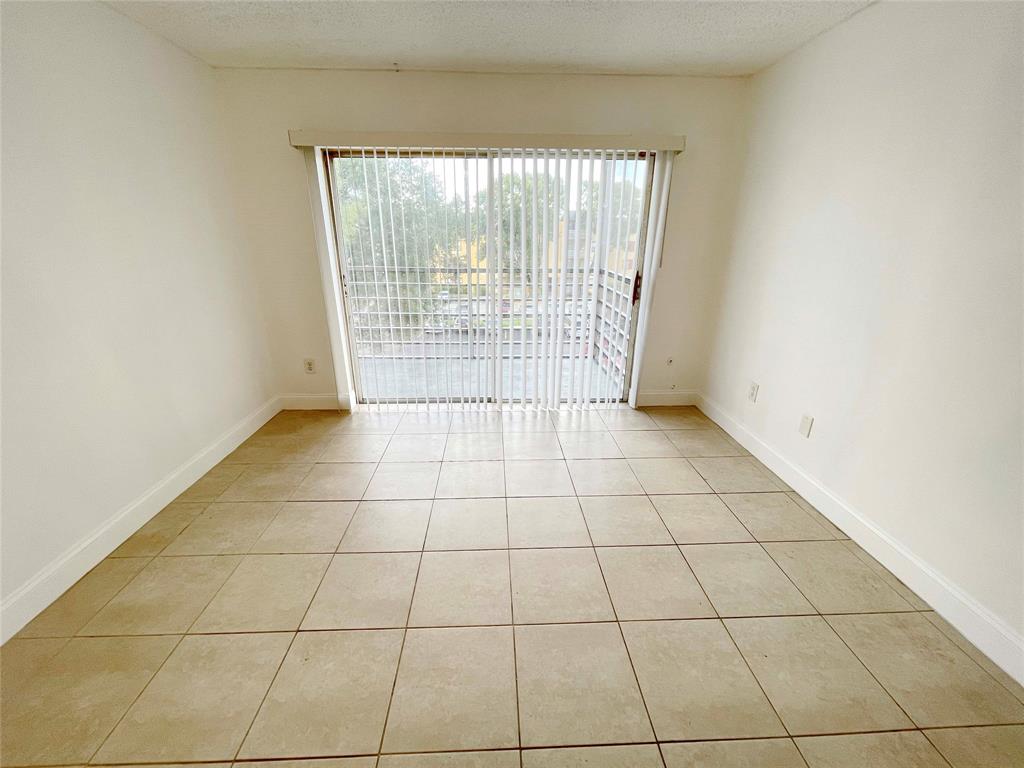 2800 Northwest 56th Avenue, Unit D402 Lauderhill, FL 33313 - Photo 4 of 14 a view of an empty room with a window