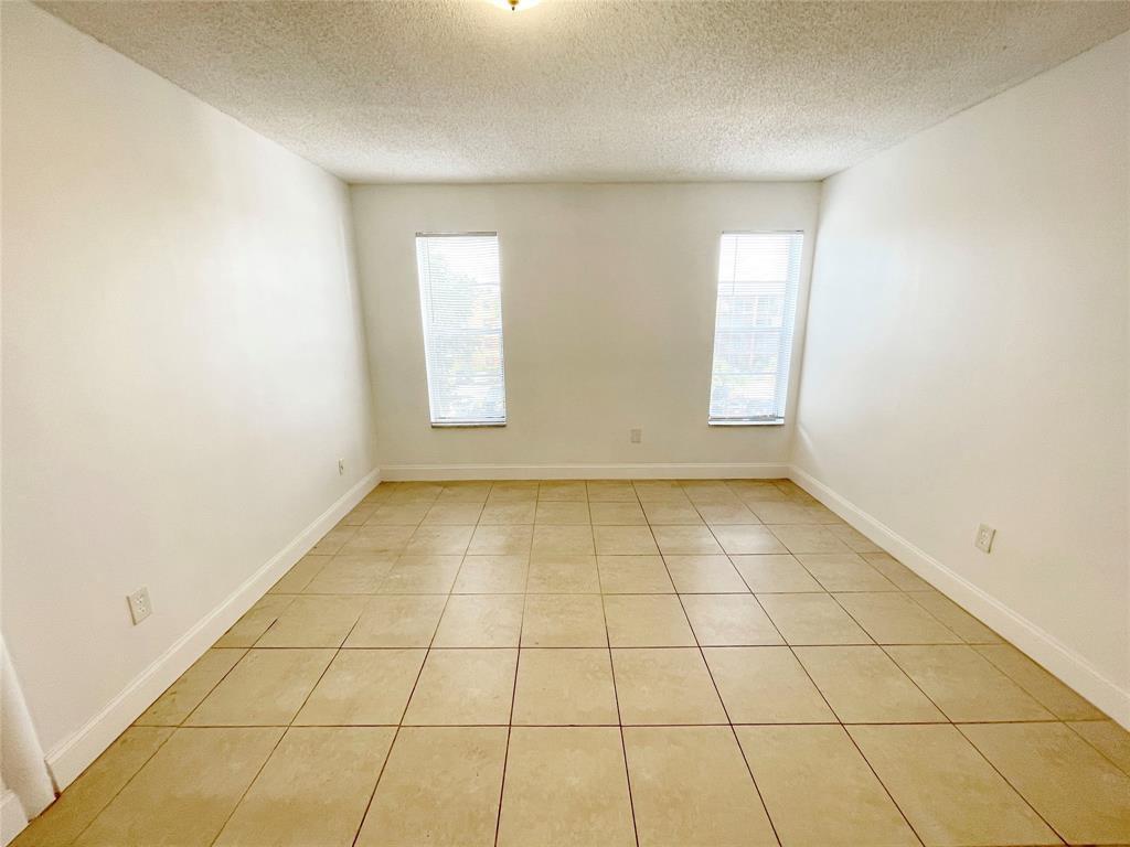 2800 Northwest 56th Avenue, Unit D402 Lauderhill, FL 33313 - Photo 6 of 14 a view of an empty room and window