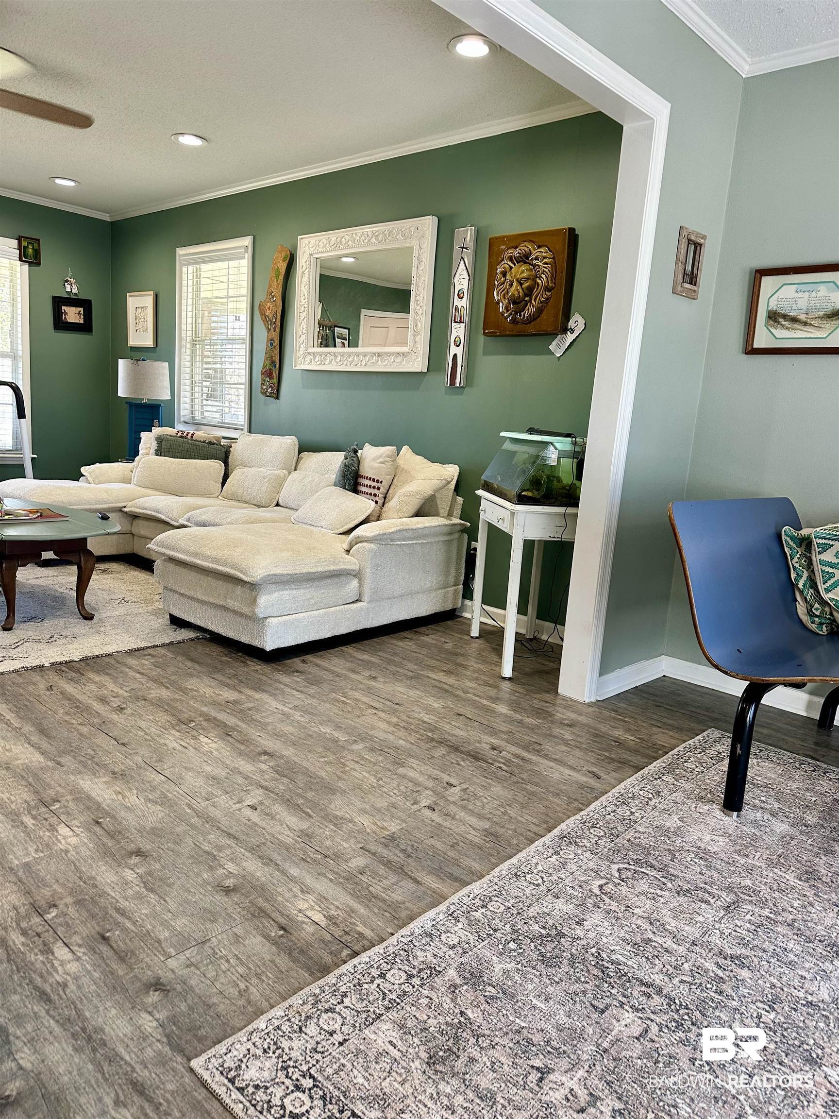 120 McGougin Road Brewton, AL 36426 - Photo 4 of 21 Living area featuring ceiling fan, crown molding, baseboards, and wood finished floors