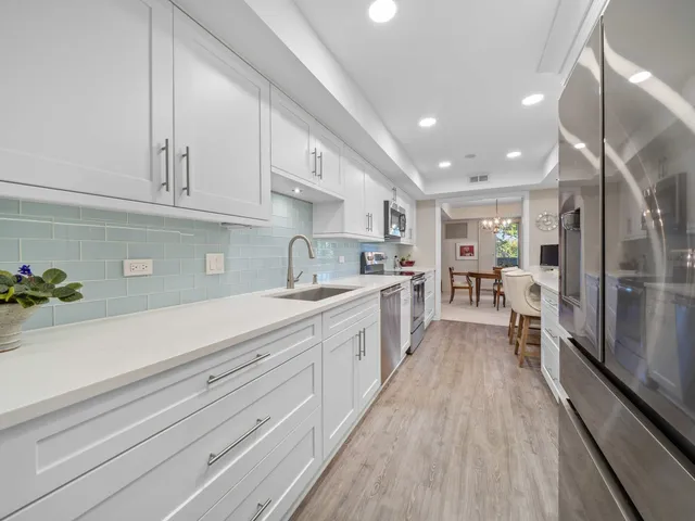 a large kitchen with stainless steel appliances lots of counter space and a sink