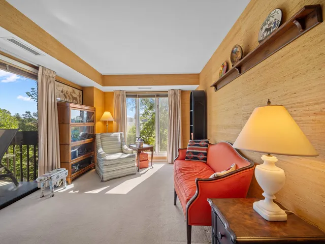 a bedroom with furniture and a large window