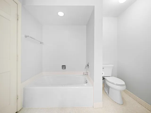 a bathroom with a bathtub and toilet