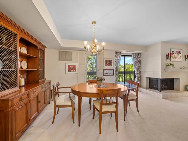 a view of a dining room with furniture and chandelier