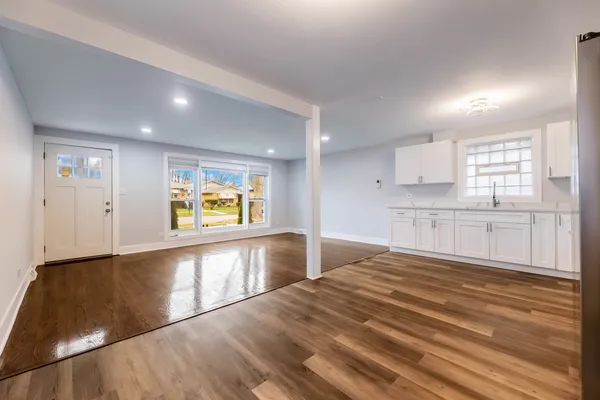 a large kitchen with kitchen island a sink stainless steel appliances and cabinets
