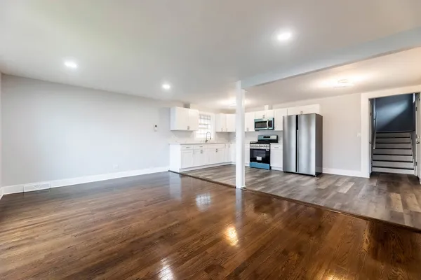 an empty room with wooden floor and an empty space