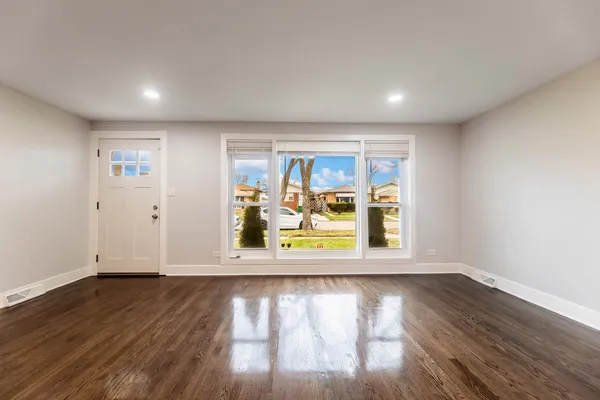 a view of kitchen with wooden floor and electronic appliances