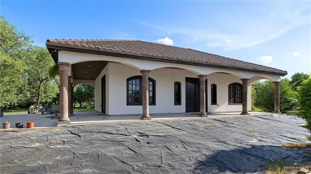a view of a house with potted plants