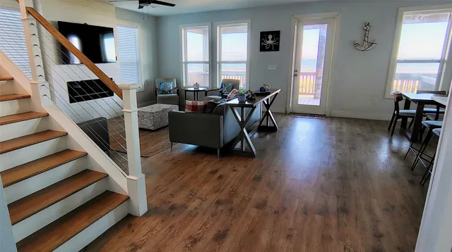 a living room with furniture and a wooden floor