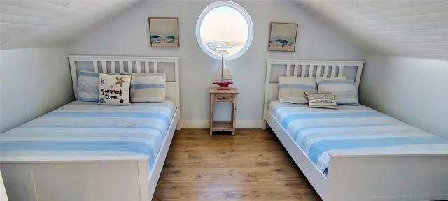 a bed room with a bed and a chair