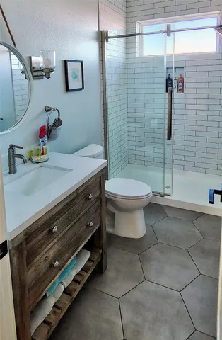 a bathroom with a sink toilet and shower