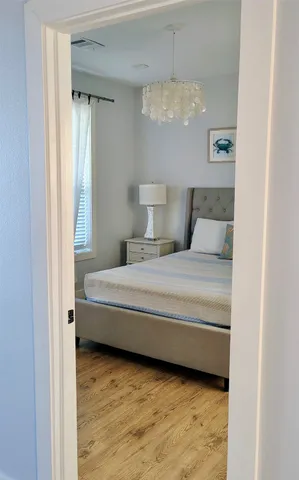 a bedroom with a bed and a night stand