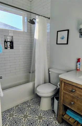 a bathroom with a toilet and a shower