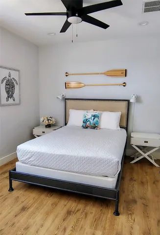 a bedroom with a bed and ceiling fan