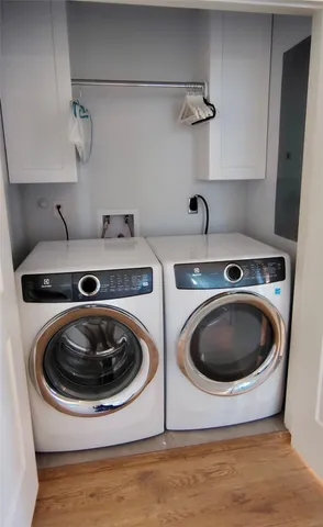 a utility room with sink dryer and washer