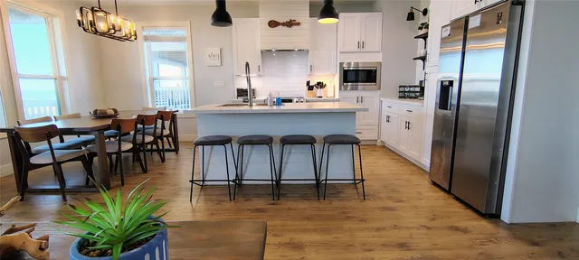 a living room with stainless steel appliances kitchen island granite countertop furniture and a kitchen view
