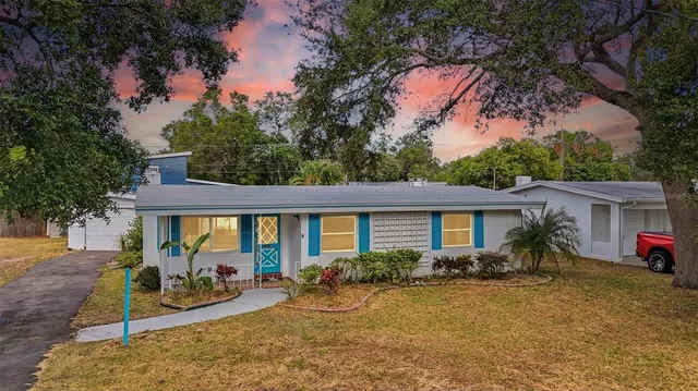 a view of a house with backyard porch and sitting area