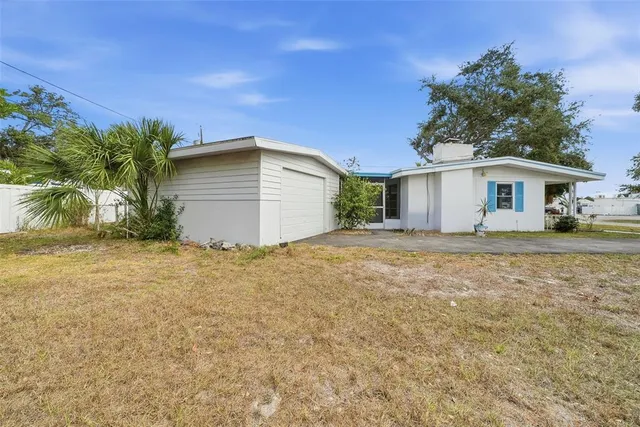 an empty room with windows and fireplace