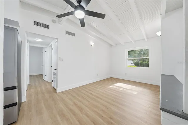 a kitchen with white cabinets and appliances
