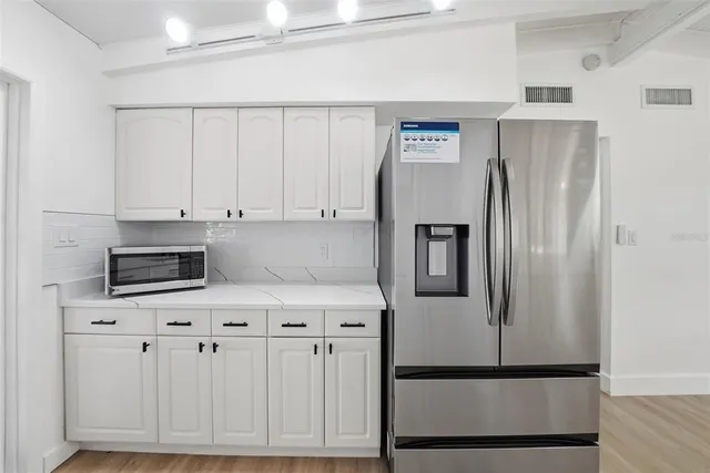 an empty room with a window and a ceiling fan