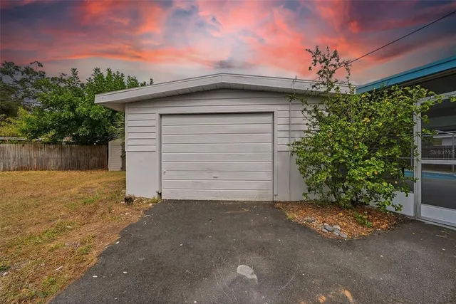 a view of backyard with wooden fence