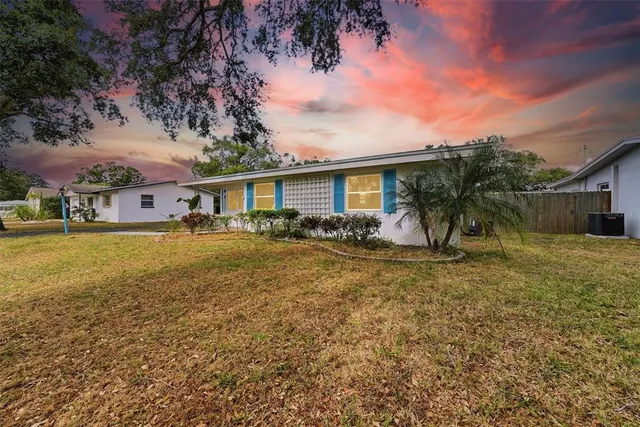 a front view of house with yard and trees