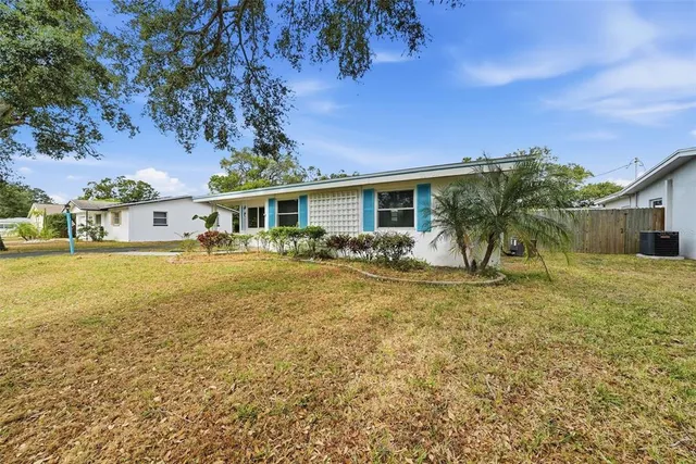 a view of an empty room with a window and fireplace