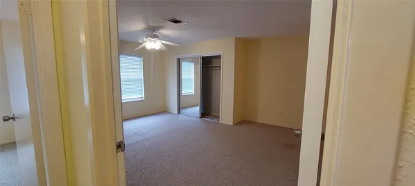 a view of a hallway with chandelier