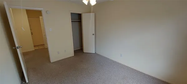 an empty room with closet area