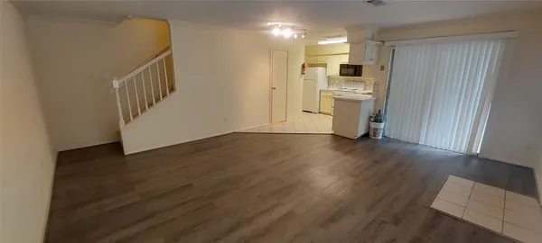 a view of a kitchen cabinets and wooden floor electronic appliances