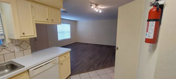 a view of storage and utility room with wooden floor