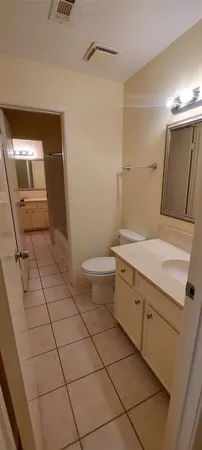 a bathroom with a sink a toilet and mirror