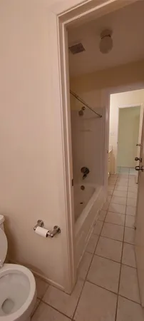 a bathroom with a granite countertop sink a toilet and shower