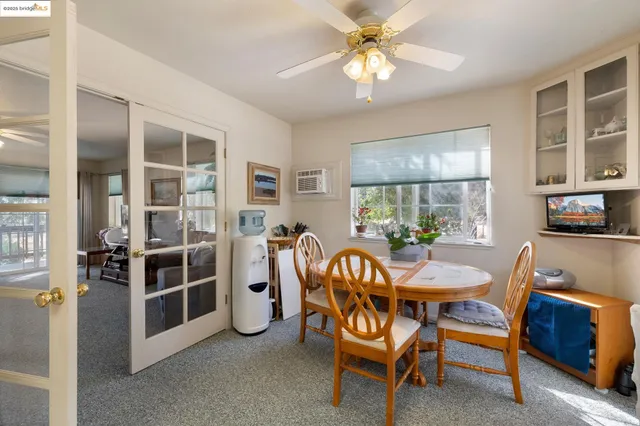 a view of a dining room with furniture and window