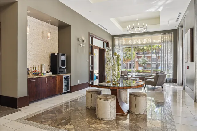 a dining hall with stainless steel appliances kitchen island granite countertop a refrigerator a stove a sink and a dishwasher