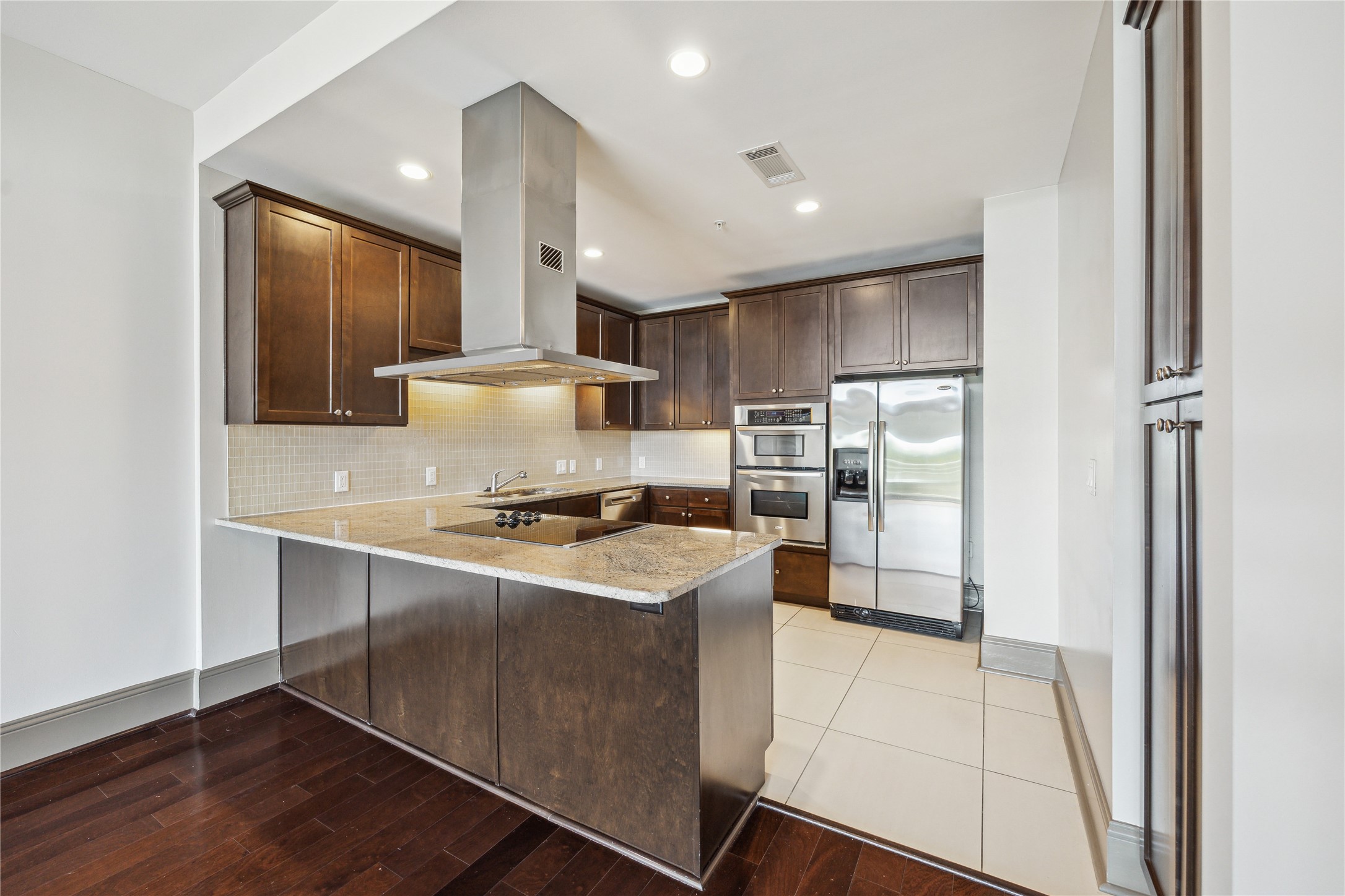 9870 Gaylord Drive, Unit 518 Houston, TX 77024 - Photo 2 of 34 a kitchen with stainless steel appliances granite countertop a stove a sink and a refrigerator