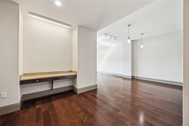 a view of room with wooden floor