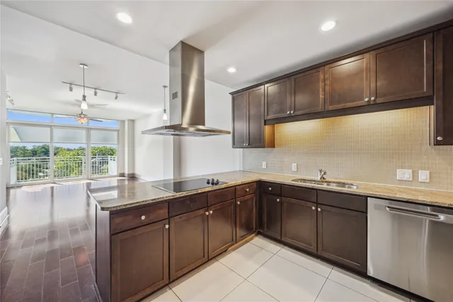 a kitchen with a sink window and cabinets